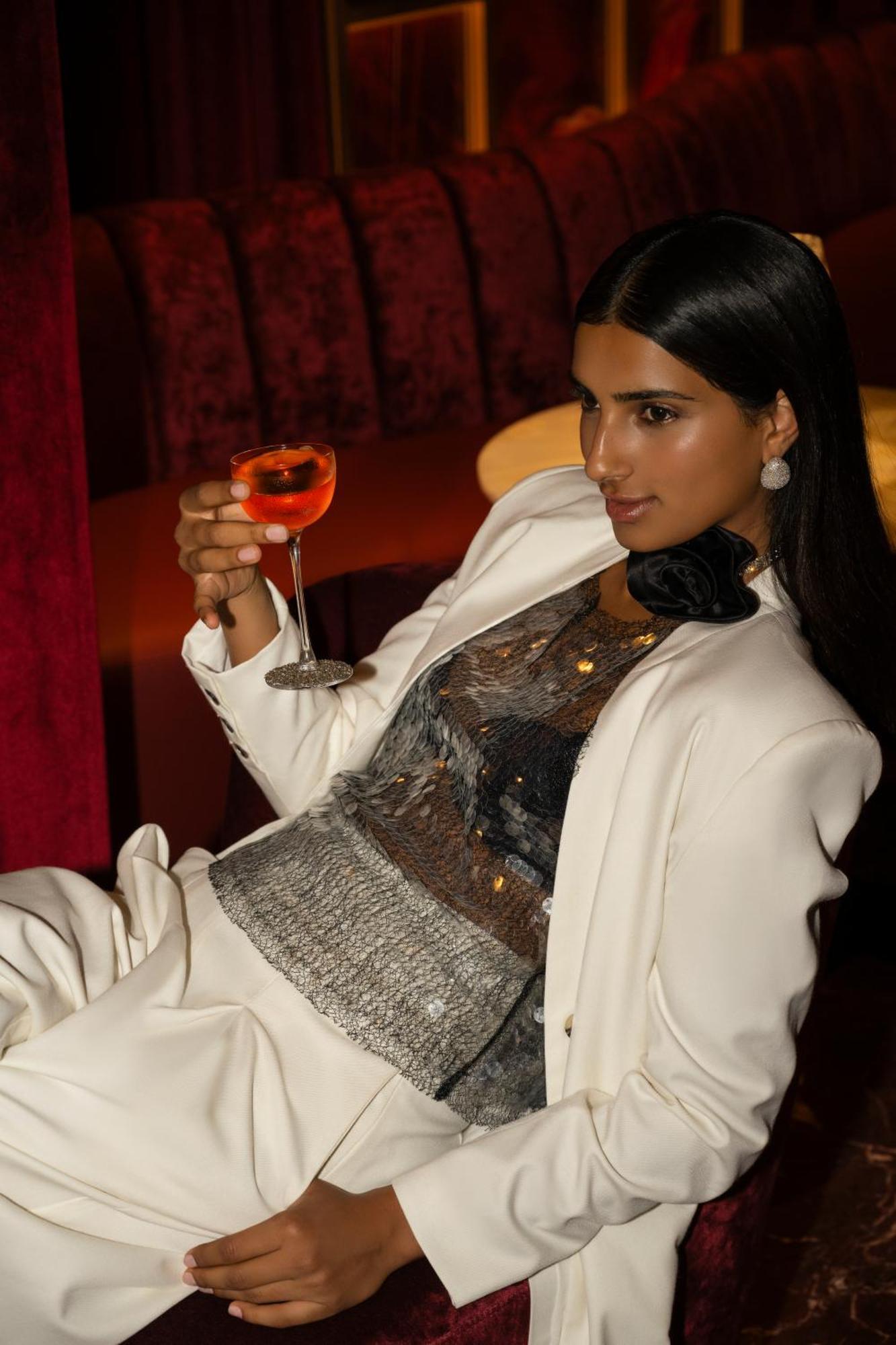 Caesars Palace Dubai Bagian luar foto A woman drinking a cocktail